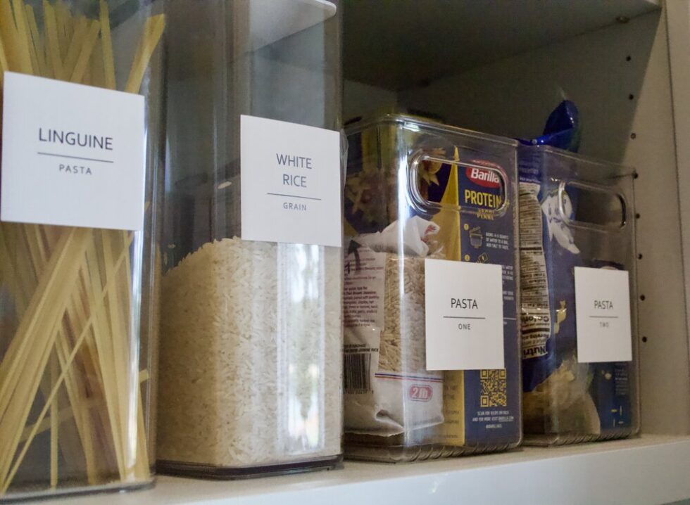 Pantry shelf with labeled containers storing linguine, white rice, and pasta.