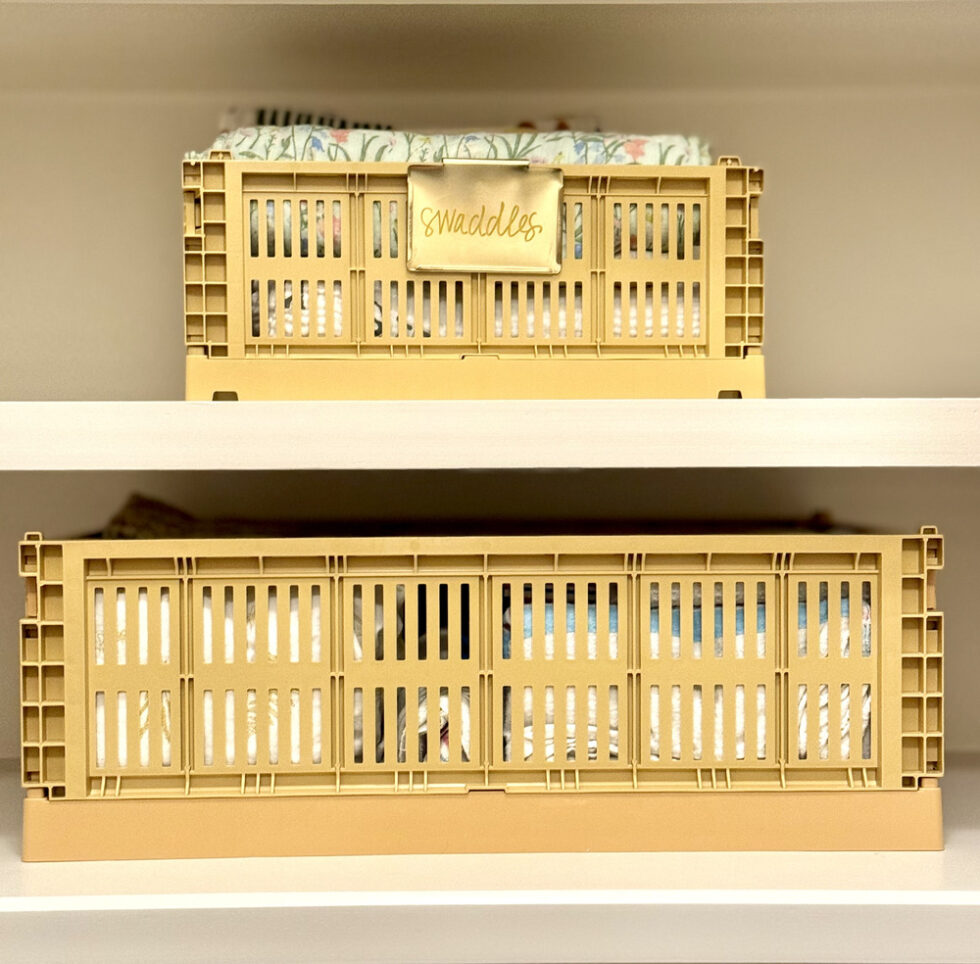 Yellow storage crates neatly arranged on white closet shelves.
